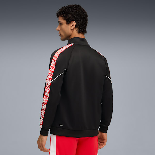 A model poses against a grey backdrop, wearing a black jacket with red patterned stripes.