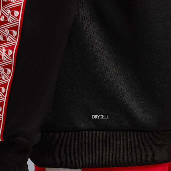 Close-up of a black top with 'DRYCELL' text and a red and white patterned stripe.