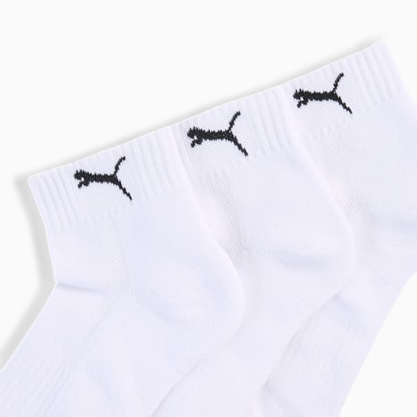 White PUMA ankle socks feature a black logo near the top opening.