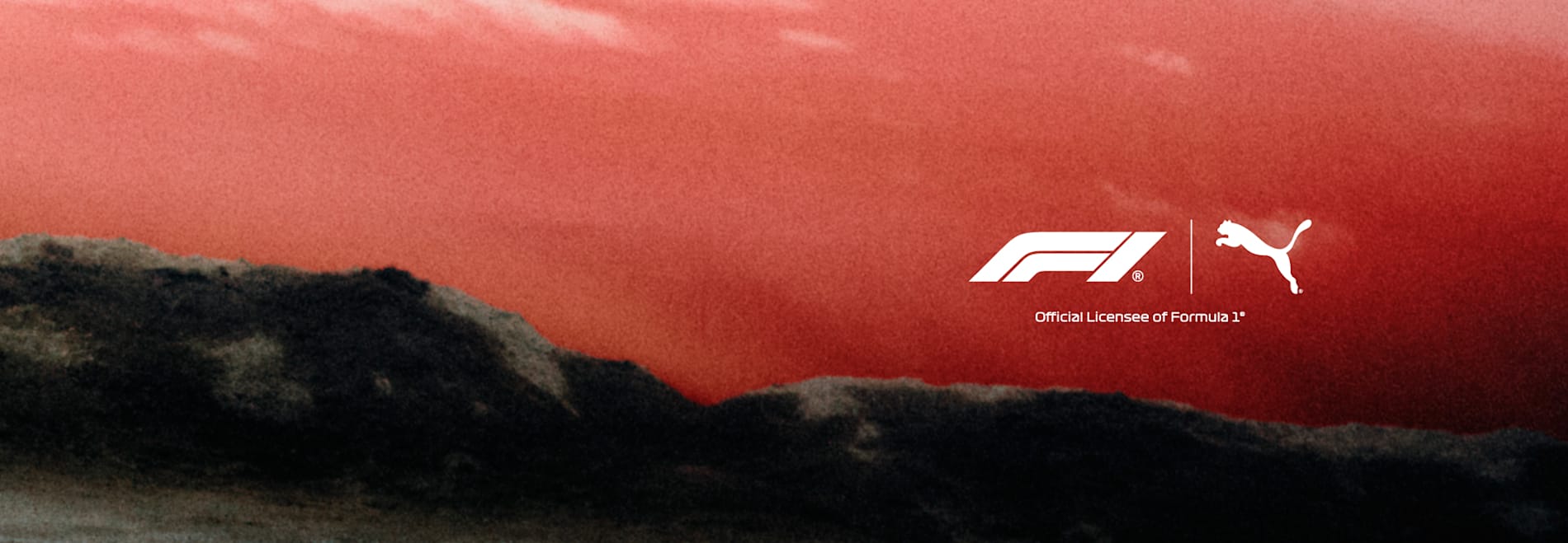 Formula 1 and Puma logos over a red sky and dark landscape backdrop.