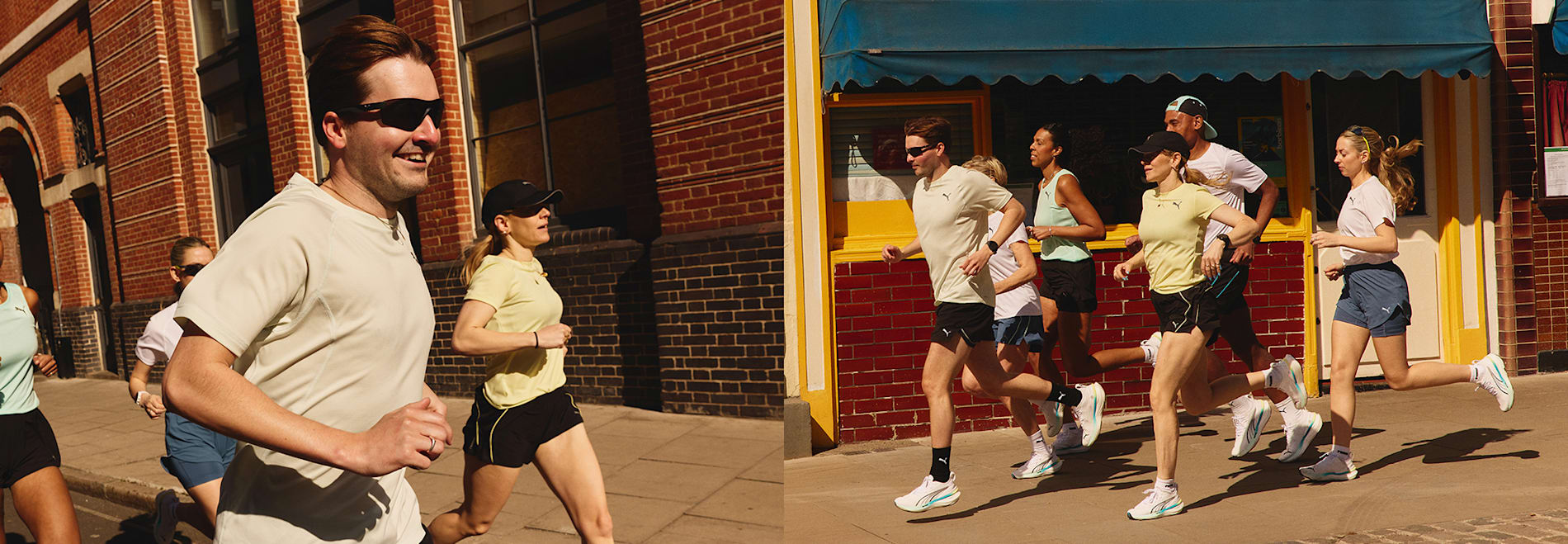 A group of runners wearing sportswear and running shoes run along a city street.