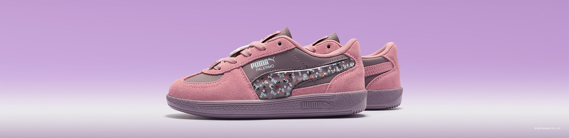 Against a lilac backdrop, a pink and mauve PUMA Palermo trainer with Hello Kitty themed accents.