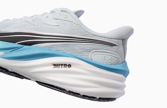 Close-up of a light blue Velocity Nitro 4 running shoe on a white background.