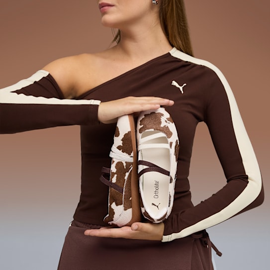 A model looks back over her shoulder, wearing zebra trainers, a black bag and bandana.