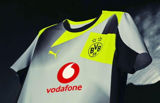 Close-up of the Borussia Dortmund away shirt, featuring club and sponsor logos on a gradient design.