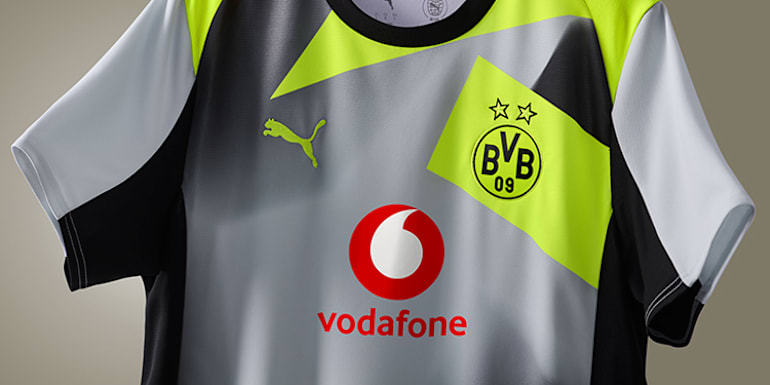 Close-up of a Borussia Dortmund away shirt featuring sponsor and club logos.