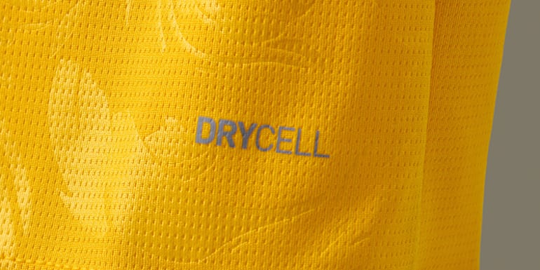 Close-up of a yellow sports jersey with a breathable texture and the 'DRYCELL' logo.